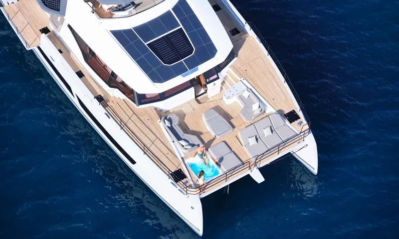 Alina: Overhead view of the foredeck with sunpads, lounge seating and two people in a jacuzzi