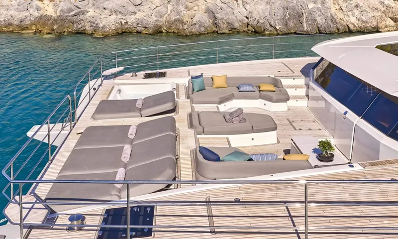 Alina: Foredeck with sunpads, rolled towels, sofas and jacuzzi near a rocky shore