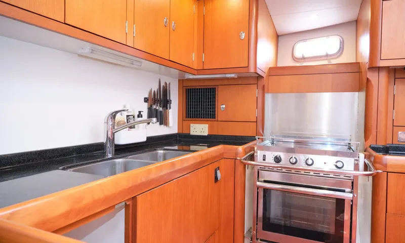 Crazy H: Galley with double sink, wooden cupboards, knife rack and stainless oven