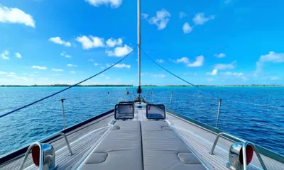 Crazy H: Foredeck sunpads with teak deck facing a calm blue lagoon