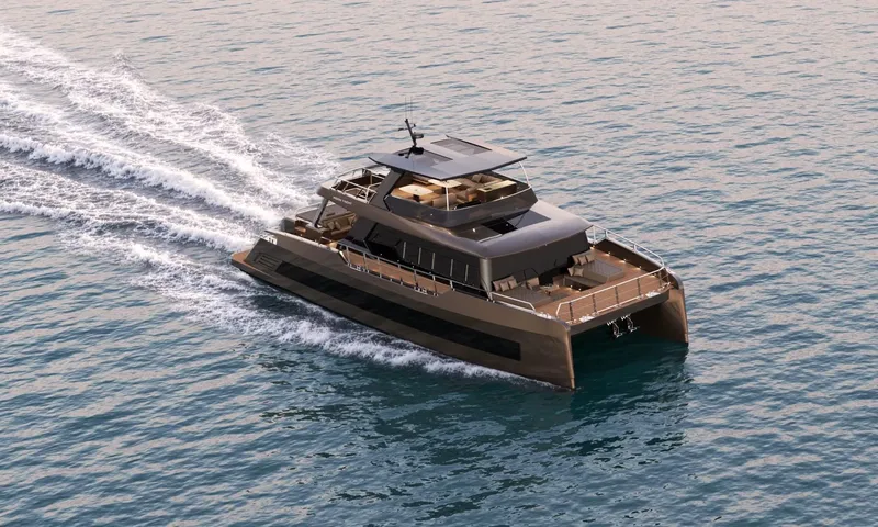 Meltemi: Bronze power catamaran under way seen from above, leaving a white wake on blue sea