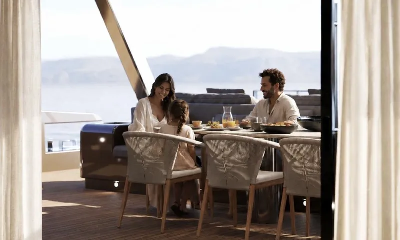 Meltemi: Family having a meal at an outdoor deck table with rope chairs and sea views