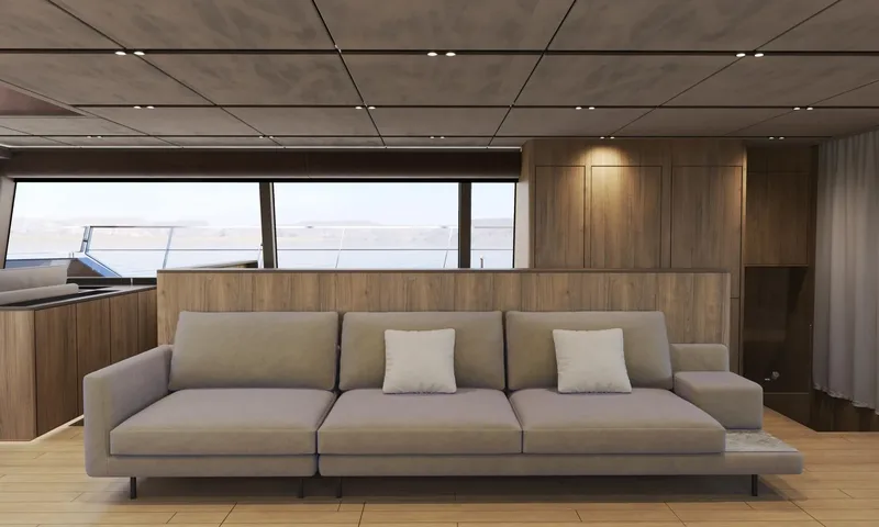 Meltemi: Grey three seat sofa against wood panelling with large windows behind