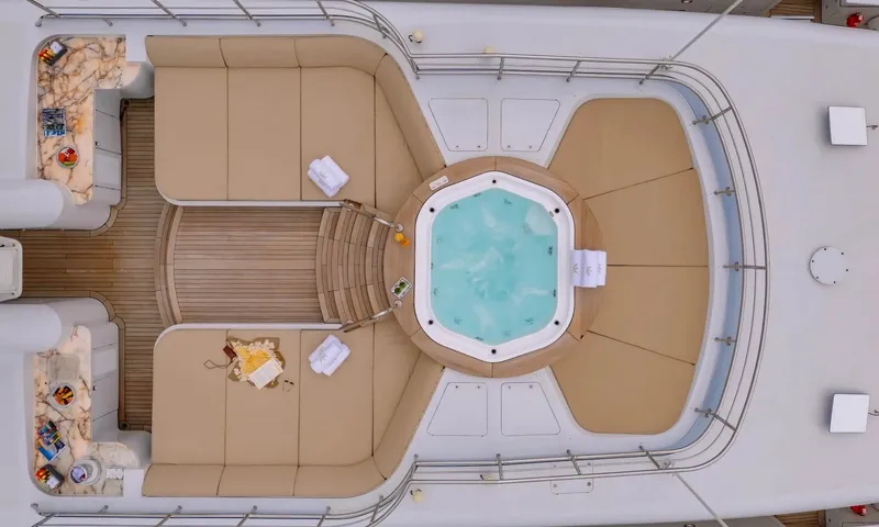 Isabell Princess of the Sea: Overhead view of a top deck jacuzzi surrounded by beige sunpads and curved seating