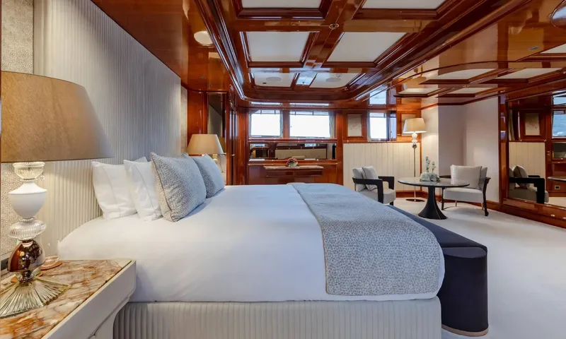 Isabell Princess of the Sea: Double bed in a wood paneled cabin with a small table and chairs by the windows