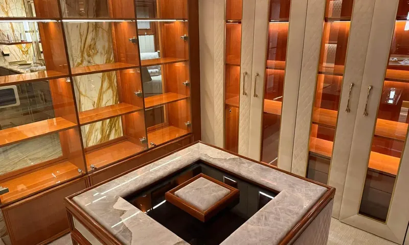 Isabell Princess of the Sea: Dressing room with marble topped island, illuminated glass shelving and cream wardrobe doors