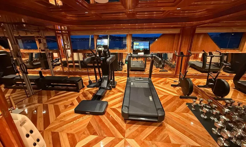 Isabell Princess of the Sea: Gym with treadmill, cross trainer, exercise bikes and dumbbell rack on parquet flooring