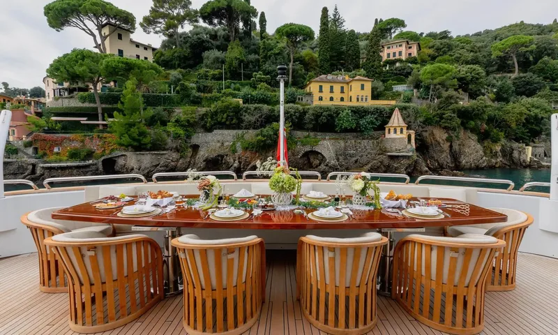 Isabell Princess of the Sea: Outdoor dining table set with flowers and breakfast, hillside villas behind