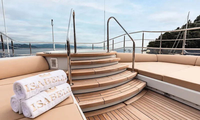 Isabell Princess of the Sea: Teak steps leading up to a deck jacuzzi beside sunpads and rolled towels