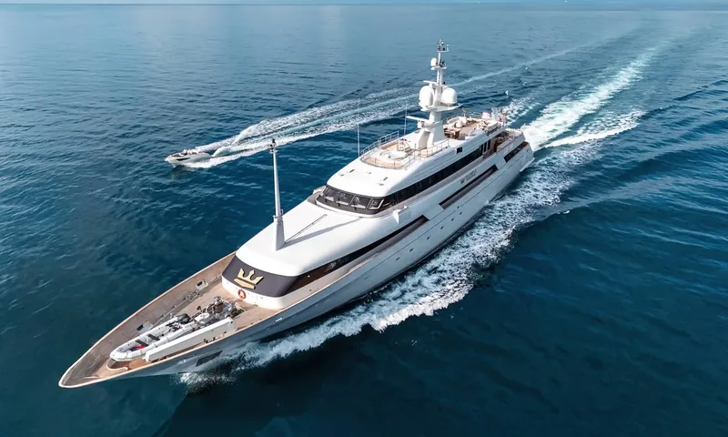 Isabell Princess of the Sea: White yacht cruising on blue sea viewed from above, followed by a tender