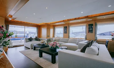 Indiana: Bright saloon with large windows, white sectional sofas and glass doors to the aft deck