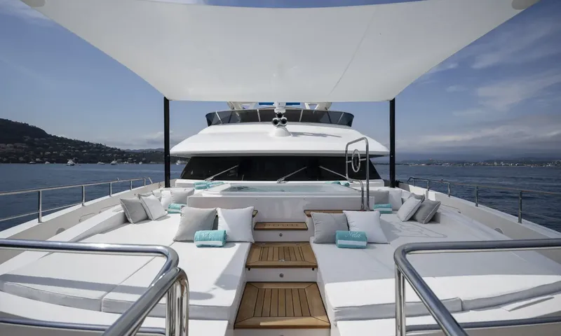 Nela: Foredeck sunpads and cushions under a shade sail with a jacuzzi in front of the bridge
