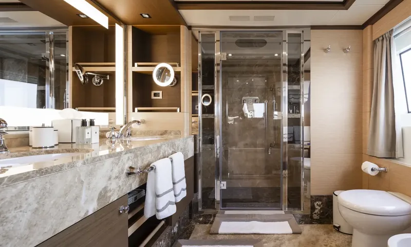 Nela: Ensuite with grey marble vanity, walk in glass shower and toilet
