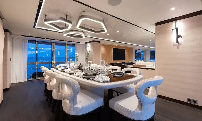 Orion: Formal dining table set for ten under hexagonal ceiling lights