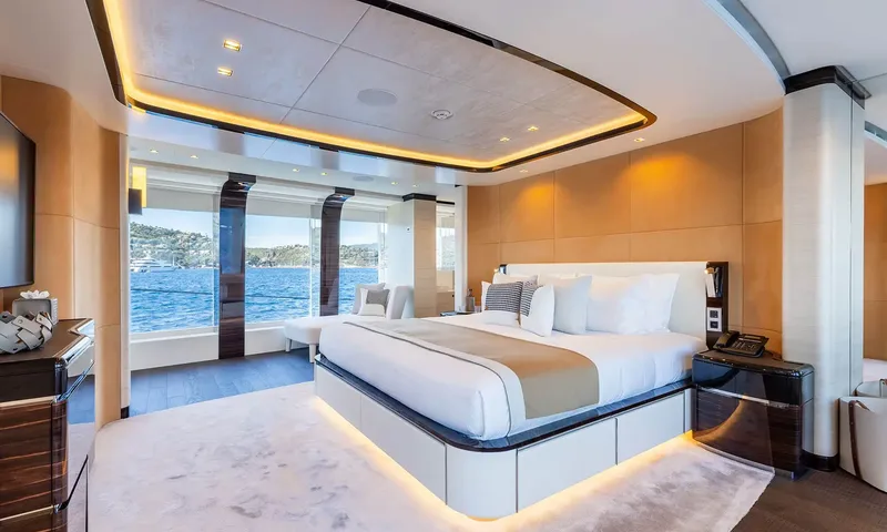 Orion: Spacious cabin with double bed facing tall windows onto the water
