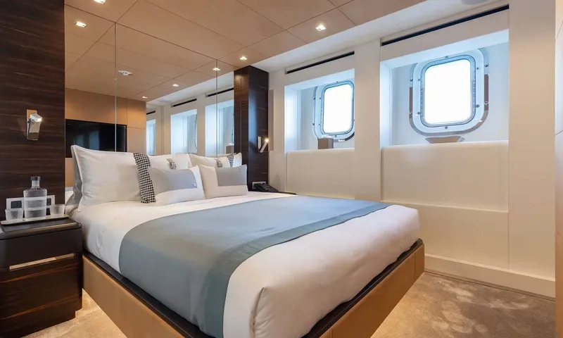 Orion: Double cabin with grey blue throw, two portholes and wood panelling
