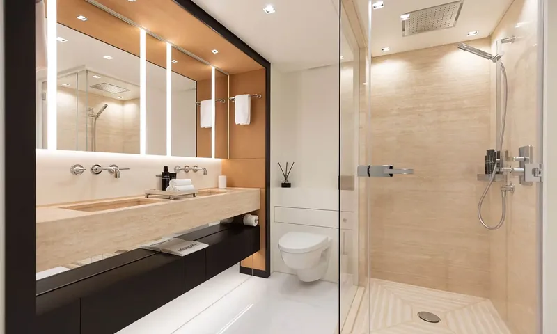 Orion: Bathroom with stone double sink, toilet and glass walk in shower