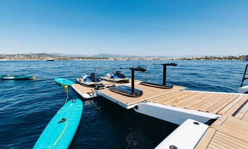 Orion: Floating dock with two jet skis, two electric hydrofoil boards and paddleboards on calm sea