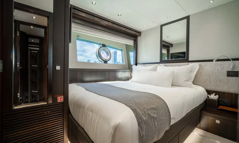 Nigora: Double cabin with grey throw, porthole window and mirrors