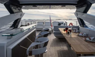 Nigora: Upper deck with bar stools, set dining table and lounge sofas facing the sea