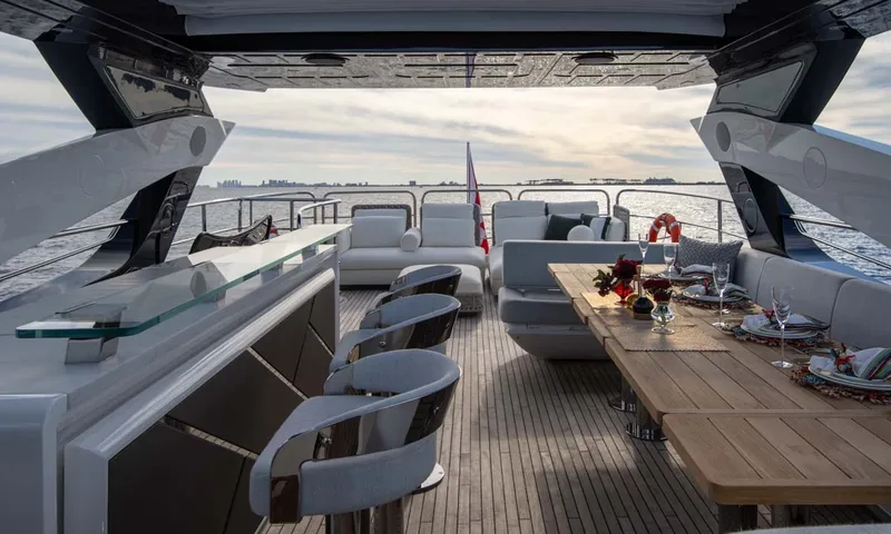Nigora: Upper deck with bar stools, set dining table and lounge sofas facing the sea