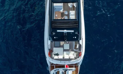 Nigora: Overhead drone view of the yacht's top deck and stern on deep blue water
